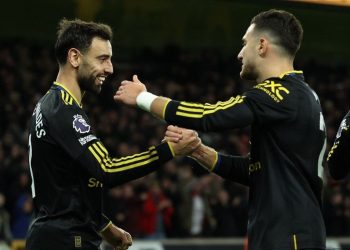 Bruno Fernandes (kiri) dan Diogo Dalot merayakan gol dalam pertandingan sepak bola Liga Inggris antara Wolves vs Manchester United di stadion Molineux di Wolverhampton, Inggris tengah pada 8 Desember 2025. (Foto oleh Darren Staples / AFP) (AFP/DARREN STAPLES)